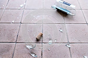 Broken glass on the floor, alcohol abuse