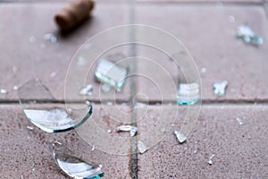 Broken glass on the floor, alcohol abuse