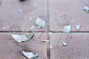 Broken glass on the floor, alcohol abuse