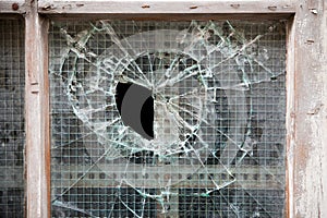 Broken glass in old wooden door