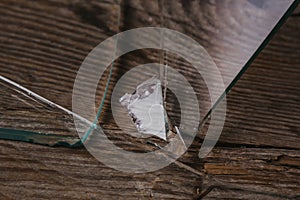 Broken glass on an old wooden floor, concept of violence