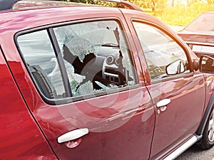 Broken glass on the passenger door of a passenger car parked. The concept of crime of car theft, theft of valuables