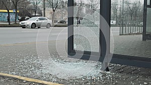 Broken glass at a public transport stop. Vandalism in the city
