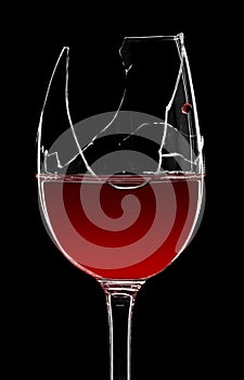 Broken glass of red wine