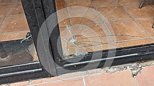 Broken glass shop window vandalism in city street