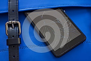 Broken glass of smart phone on the blue