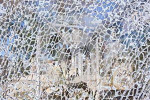 Broken glass surface with garden background at bottom