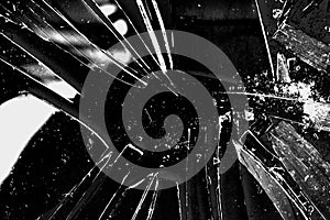 Broken glass texture background in black and white with many pieces and shattered parts. Styled stock photo useful for wallpapers