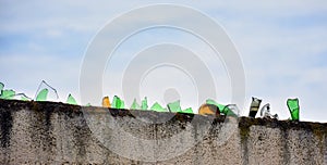 Broken glass on top of a wall