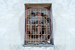 Broken glass window with bars