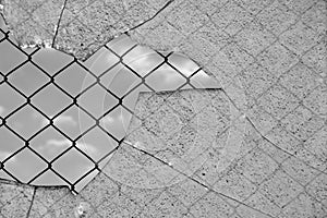 Broken glass and wired fence photo