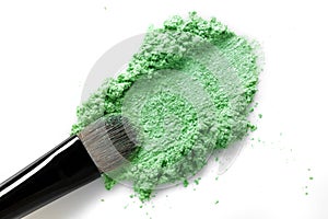 Broken green eye shadow and makeup brush isolated on white background