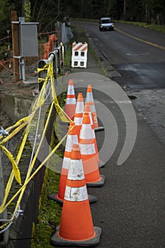 Broken guardrail with tape and traffic cones