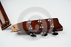 Broken guitar neck on a white background with copy space
