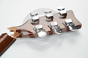 Broken guitar neck on a white background with copy space