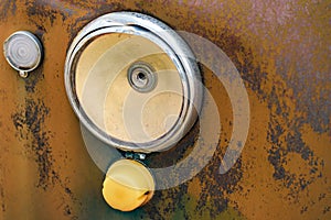 Broken head light of old rusty car