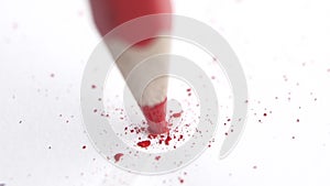 Broken head of sharp red pencil on a white, slow