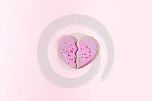 Broken heart, breakup, separation, divorce, significant other concept. Two halves of one heart on a pink background. Loss,