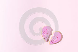 Broken heart concept. Divorse, quarrel. significant other. broken cookie in heart shape on pink background. Family psychotherapist