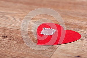 Broken heart lost on wooden floor background