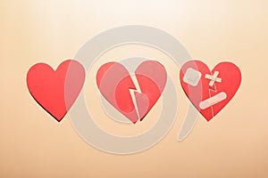 broken heart near heart with patches isolated on brown background, soul healing concept