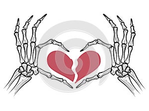 Broken heart in skeleton hands photo