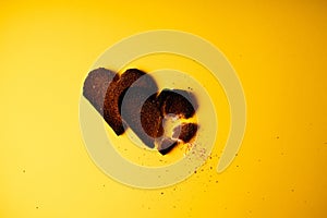 Broken hearted. Two burnt hearts made of white toast bread on yellow background.