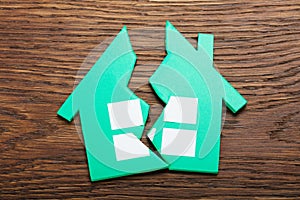 Broken Home On Wooden Table