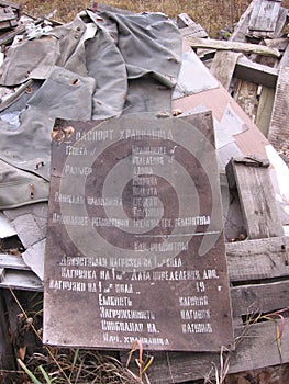 Broken information signs with inscriptions lying in the garbage thrown into the landfill