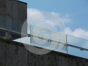 broken laminated safety glass balustrade. stainless steel fastener brackets