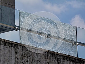 broken laminated safety glass balustrade. stainless steel fastener brackets