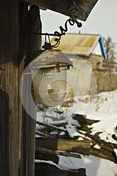 Broken lantern on the wall of an old barn