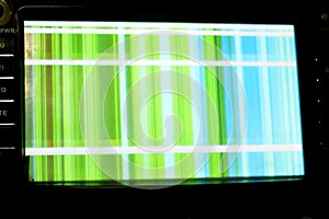 Broken LCD screen with multiple colors and pixelations with color errors and problems forming abstract color stripes background in photo
