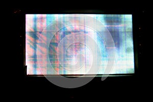 Broken LCD screen with multiple colors and pixelations with color errors and problems forming abstract color stripes and patches photo