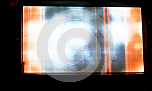 Broken LCD screen with multiple colors and pixelations with color errors and problems forming abstract color stripes and patches photo
