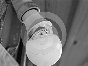 Broken led bulb hanging on wall