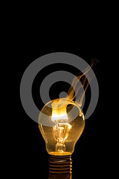 Broken light bulb burn out with flame