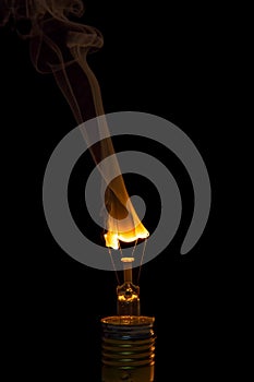 Broken light bulb burn out with flame