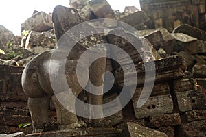 Broken lion statue in angkorian temple