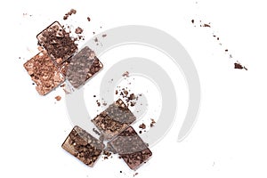 Broken make up and cosmetic products. Smashed eye shadow palette in neutral colors isolated on white background