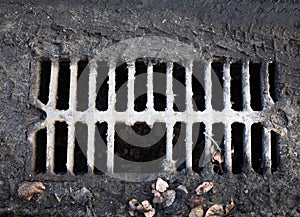 Broken drain grate with mud