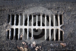 Broken drain grate with mud
