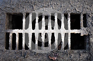 Broken drain grate with mud