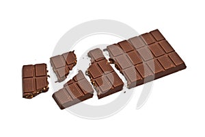 Broken milk chocolate bar with hazelnuts isolated on white