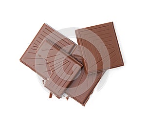 Broken milk chocolate bar on white background, top view