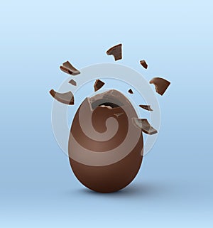 Broken milk chocolate egg on light blue background