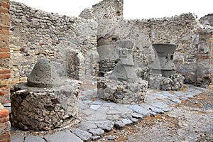 Broken mills in Roman Pompeii, Italy photo