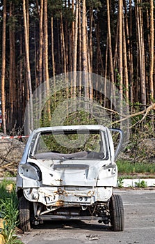 Broken minicar after a traffic accident in the parking lot of a repair station.