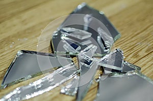 Broken mirror fragments, bad omen, superstition. Close-up, selective focus photo