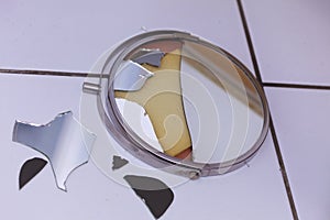 Broken mirror lying on ground